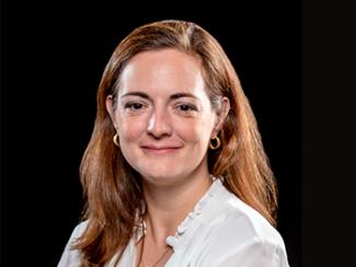 Headshot of Helen Genova on a black background