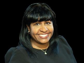 Headshot of Soroya Campbell on a black background