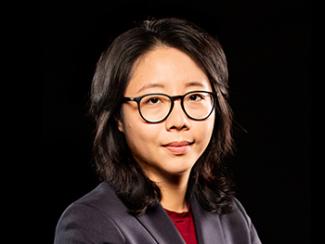 Headshot of Ada X. Chen with black background