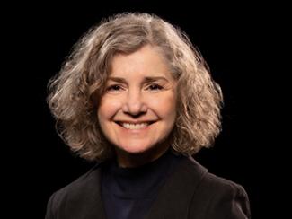 Headshot of Laura Marino on a black background