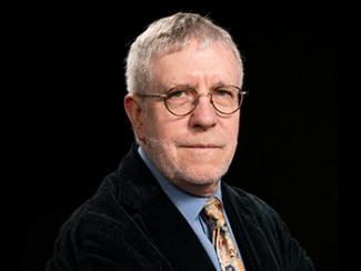 Headshot of John O'Neill, PhD with a Black Background