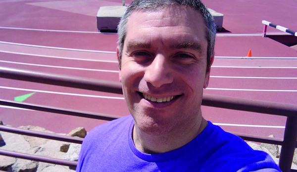 man smiling on running track