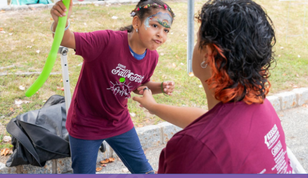 A child with face paint participates in an activity at Kessler Foundation's Fall Fest. Below, event volunteers and staff wearing matching Fall Fest T-shirts sit and stand behind an information table featuring community resources and research materials. The image includes the Kessler Foundation Fall Fest logo.