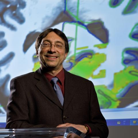 Dr. John DeLuca with brain image in background