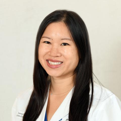 Head-shot of Dr. Beverly Hon against a black background 