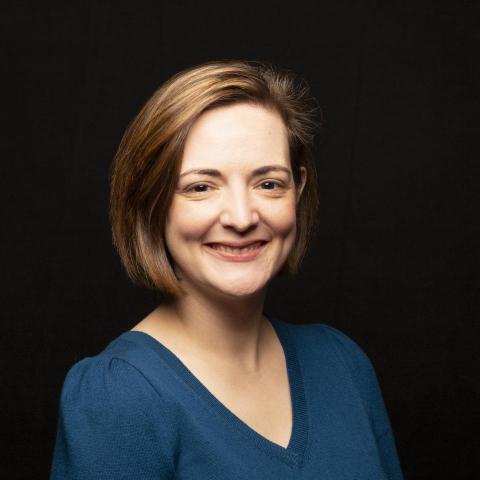 Headshot photo of Dr. Helen Genova against black background 