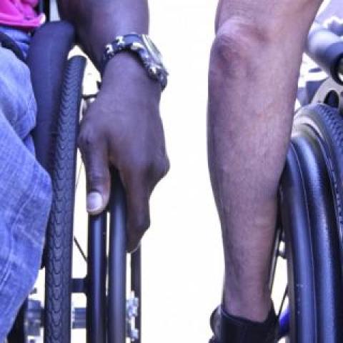 two individuals in wheelchairs side-by-side