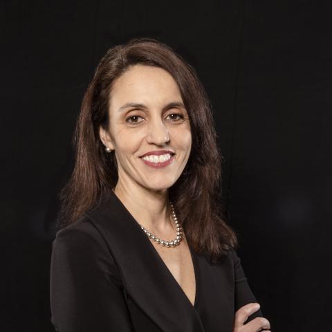Dr. Amanda Botticello standing against a black background 