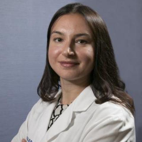 dr boukrina wearing a white lab coat with arms crossed