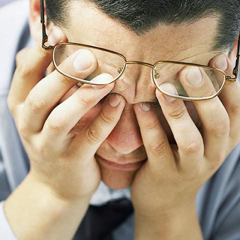 Man with head in hands experiencing depression