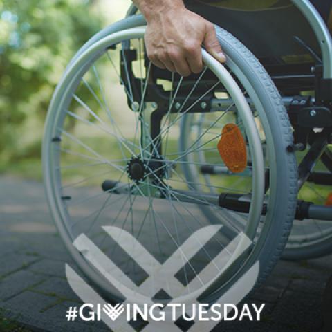 Wheelchair user with Giving Tuesday logo
