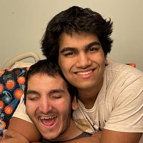 Brother Contributes Invaluable Resource to TBI Community Two brothers smiling and hugging one another