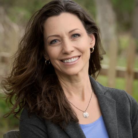 Headshot of Stacia Bissell, MEd. She is wearing a gray blazer and light blue top.