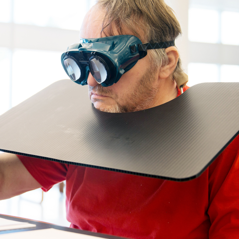 Man is wearing prism adaptation lenses and writing on a piece of paper