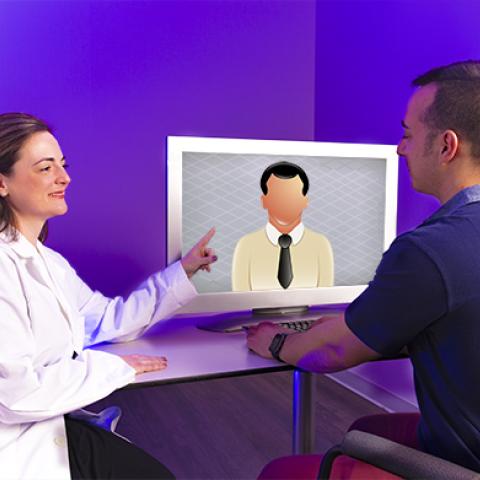 Photo of Helen Genova and Alec De Graaf using virtual reality