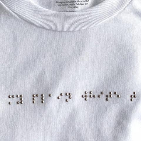 White shirt with braille on the front side