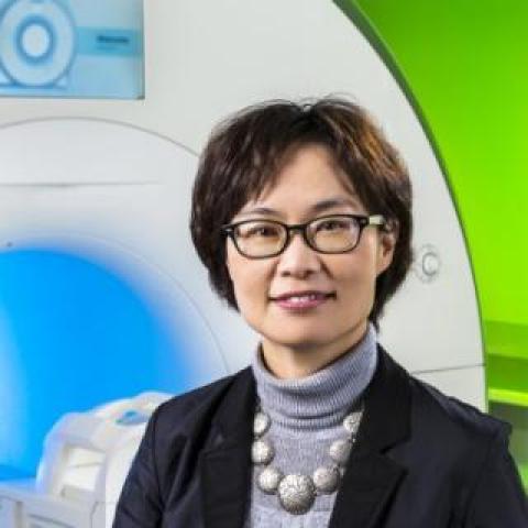 Dr oh Park standing near a MRI imaging scanner system at Kessler Foundation