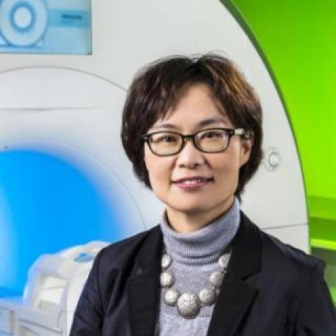 Dr Oh Park standing in front of the MRI Scanner