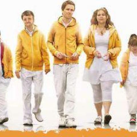 family waring white pants and yellow matching shirts