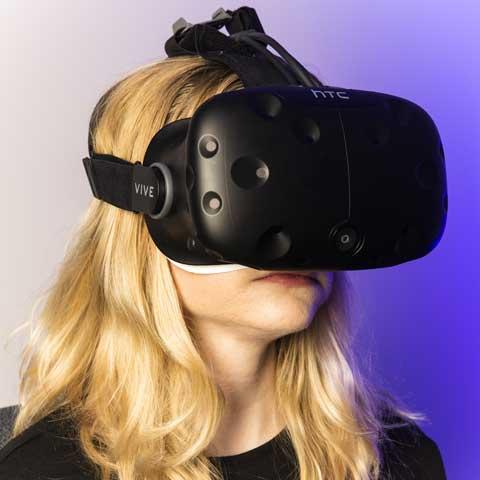 Blond woman wearing a virtual reality goggle device