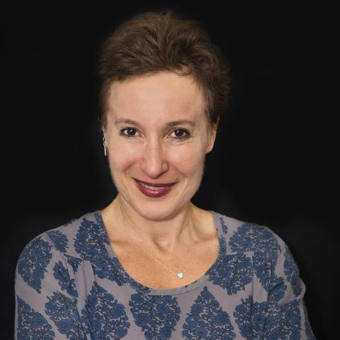 Head shot of Dr. Yael Goverover against a black background 