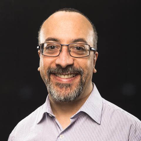 Dr. Anthony Lequerica wearing a plait shirt