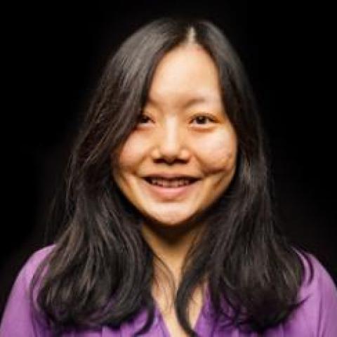 Head-shot of Dr. Xuan Liu against a black background