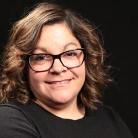 lauren strober with arms crossed wearing a black shirt