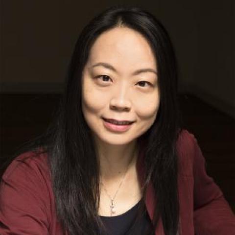 dr chen wearing a black shirt, red jacket and silver necklace