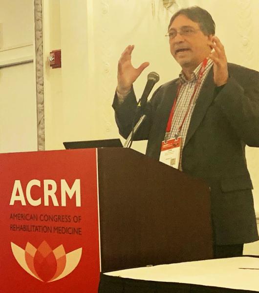 Photo of Dr. John DeLuca presenting at the ACRM conference 