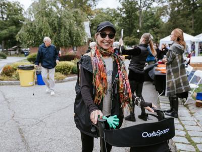 A woman in an outdoor setting using a walker for mobility support