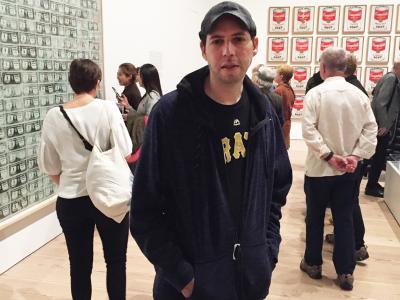 Kenny Diamond standing in an art gallery