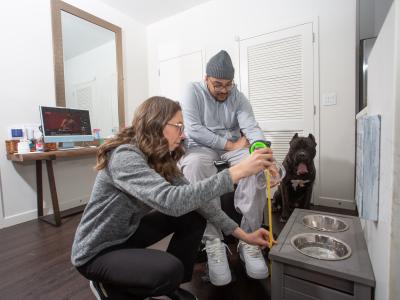 Louis Ayala with dog and SCI Navigator at home 