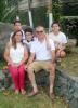 Family 2 parents and 3 children posing for a picture sitting on a rock