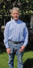 A man wearing a button down in the outdoors